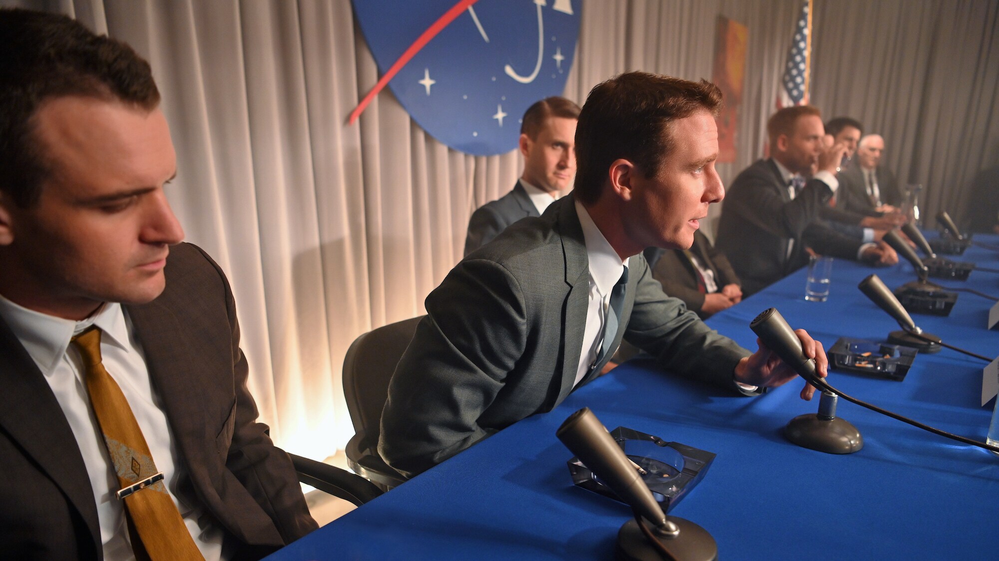 Alan Shepard (second from left), played by Jake McDorman, and the other Mercury astronauts during a press conference in National Geographic's THE RIGHT STUFF streaming on Disney+. (National Geographic/Gene Page)