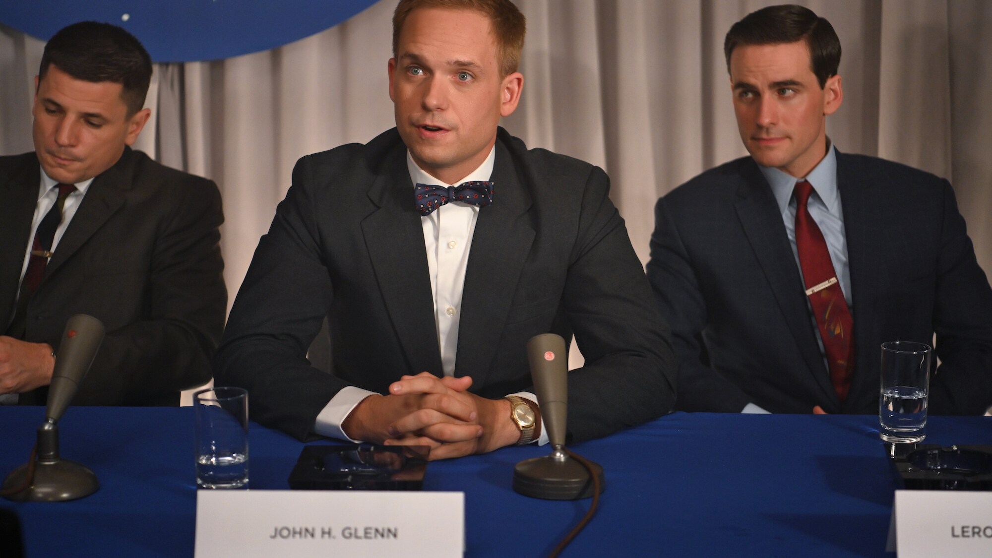 Mercury astronauts, John Glenn (center) played by Patrick J. Adams, Gus Grissom (L) played by Michael Trotter and Gordon Cooper (R) played by Colin O’Donoghue, during a press conference in National Geographic's THE RIGHT STUFF streaming on Disney+.