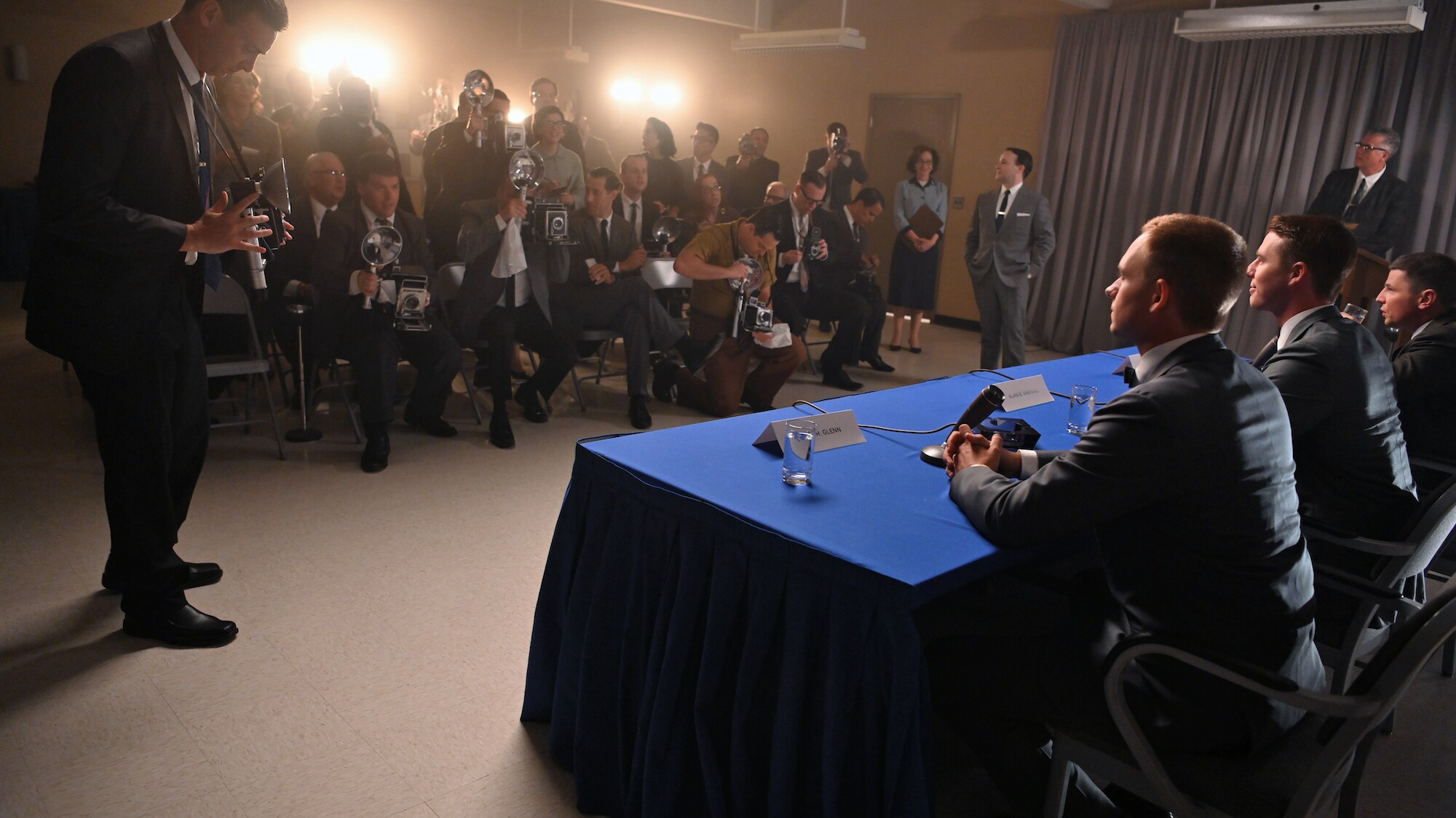 Patrick J. Adams as John Glenn, Jake McDorman as Alan Shepard and Michael Trotter as Gus Grissom during a press conference in National Geographic's THE RIGHT STUFF streaming on Disney+. (National Geographic/Gene Page)