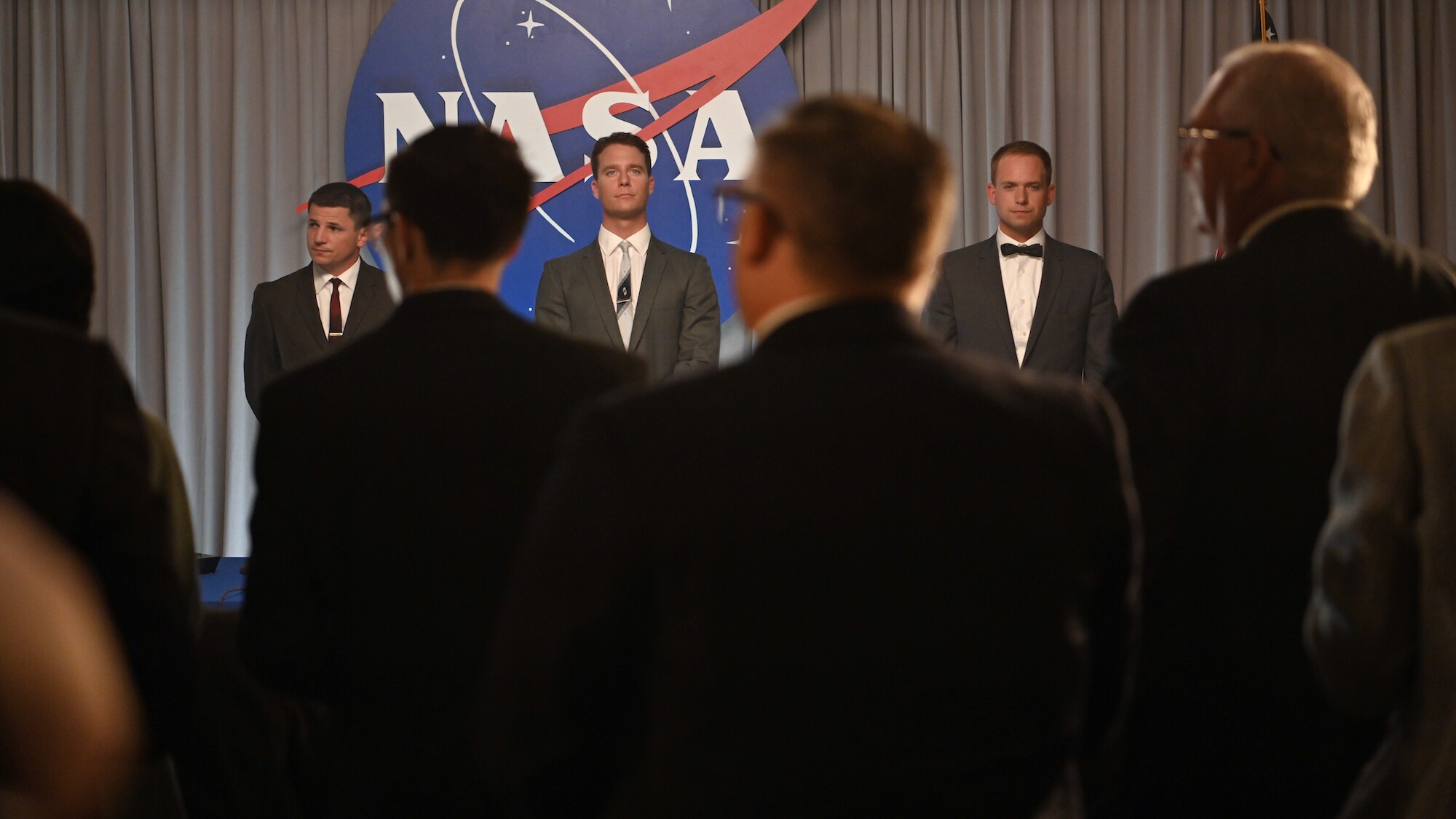 Back L to R: Michael Trotter as Gus Grissom, Jake McDorman as Alan Shepard and Patrick J. Adams as John Glenn during a press conference in National Geographic's THE RIGHT STUFF streaming on Disney+. (National Geographic/Gene Page)