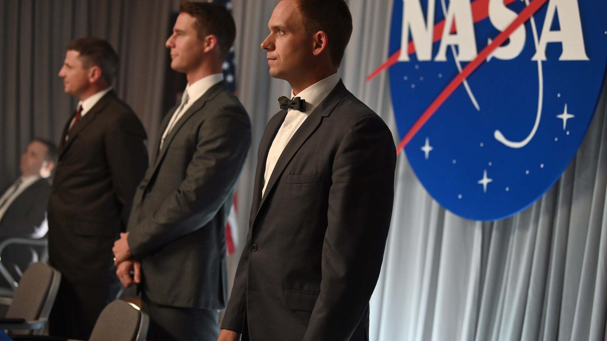 L to R: Michael Trotter as Gus Grissom, Jake McDorman as Alan Shepard and Patrick J. Adams as John Glenn during a press conference in National Geographic's THE RIGHT STUFF streaming on Disney+. (National Geographic/Gene Page)