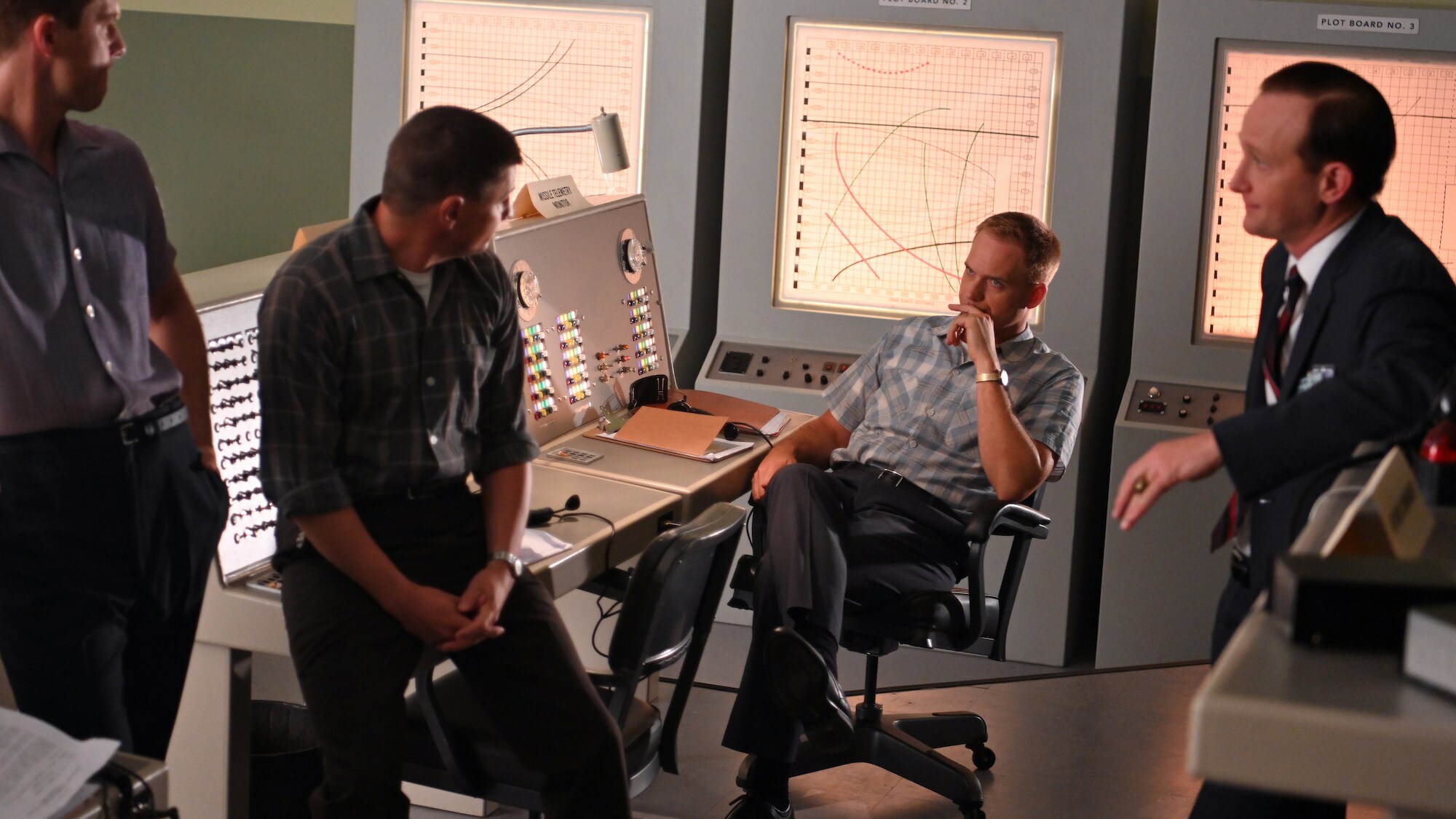 L to R: Jake McDorman as Alan Shepard, Michael Trotter as Gus Grissom, Patrick J. Adams as John Glenn and Eric Ladin as Chris Kraft discuss concerns from the President’s Science Advisory Committee and the future of the space program in National Geographic's THE RIGHT STUFF streaming on Disney+. (National Geographic/Gene Page)