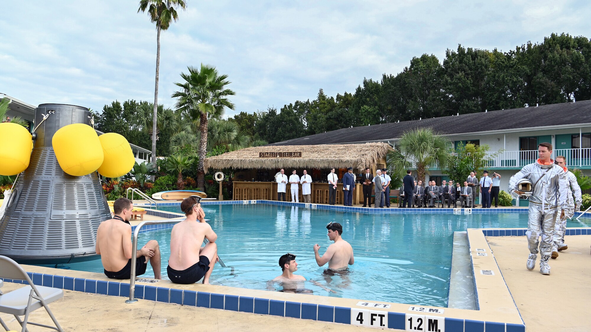 Mercury Seven astronauts during an emergency procedure demonstration in a swimming pool for Dr. Jerome Wiesner and other members of the President’s Science Advisory Committee (not pictured) in National Geographic's THE RIGHT STUFF streaming on Disney+. (Credit: National Geographic/Gene Page)