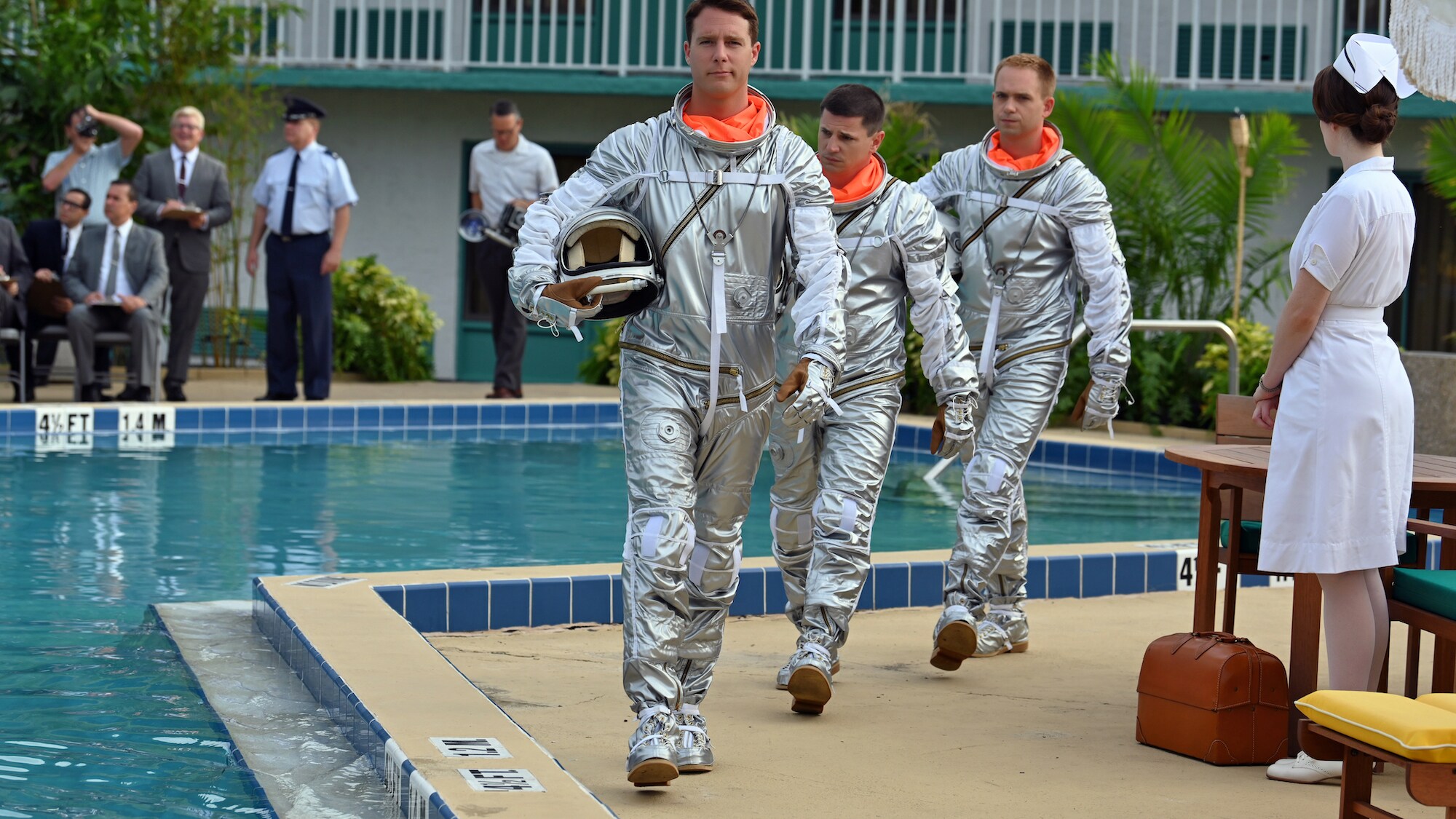 Mercury Seven astronauts (L to R), Alan Shepard played by Jake McDorman, Gus Grissom played by Michael Trotter and John Glenn played by Patrick J. Adams, prior to performing an emergency procedure demonstration in a swimming pool for Dr. Jerome Wiesner and other members of the President’s Science Advisory Committee (not pictured) in National Geographic's THE RIGHT STUFF streaming on Disney+. (Credit: National Geographic/Gene Page)