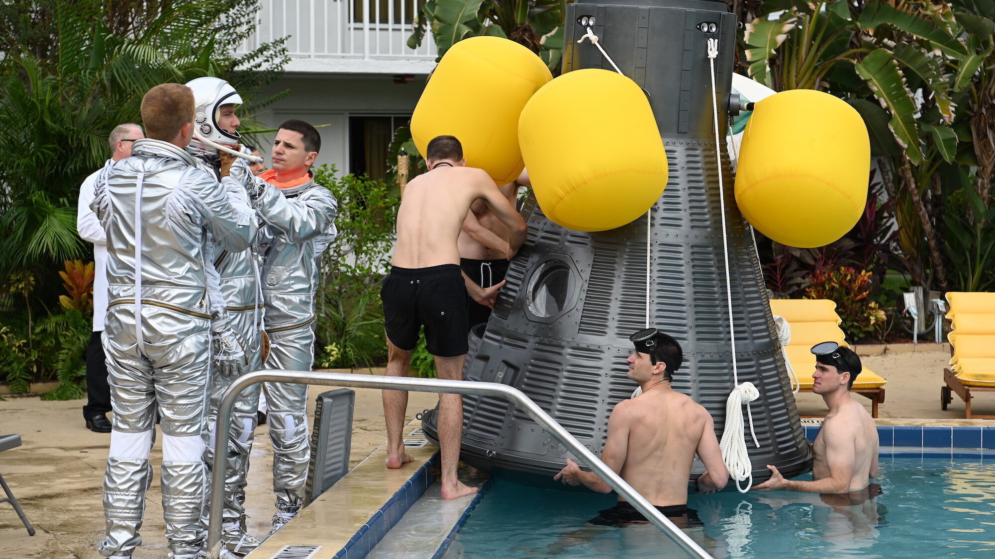 Mercury Seven astronauts during an emergency procedure demonstration in a swimming pool for Dr. Jerome Wiesner and other members of the President’s Science Advisory Committee (not pictured) in National Geographic's THE RIGHT STUFF streaming on Disney+. (Credit: National Geographic/Gene Page)