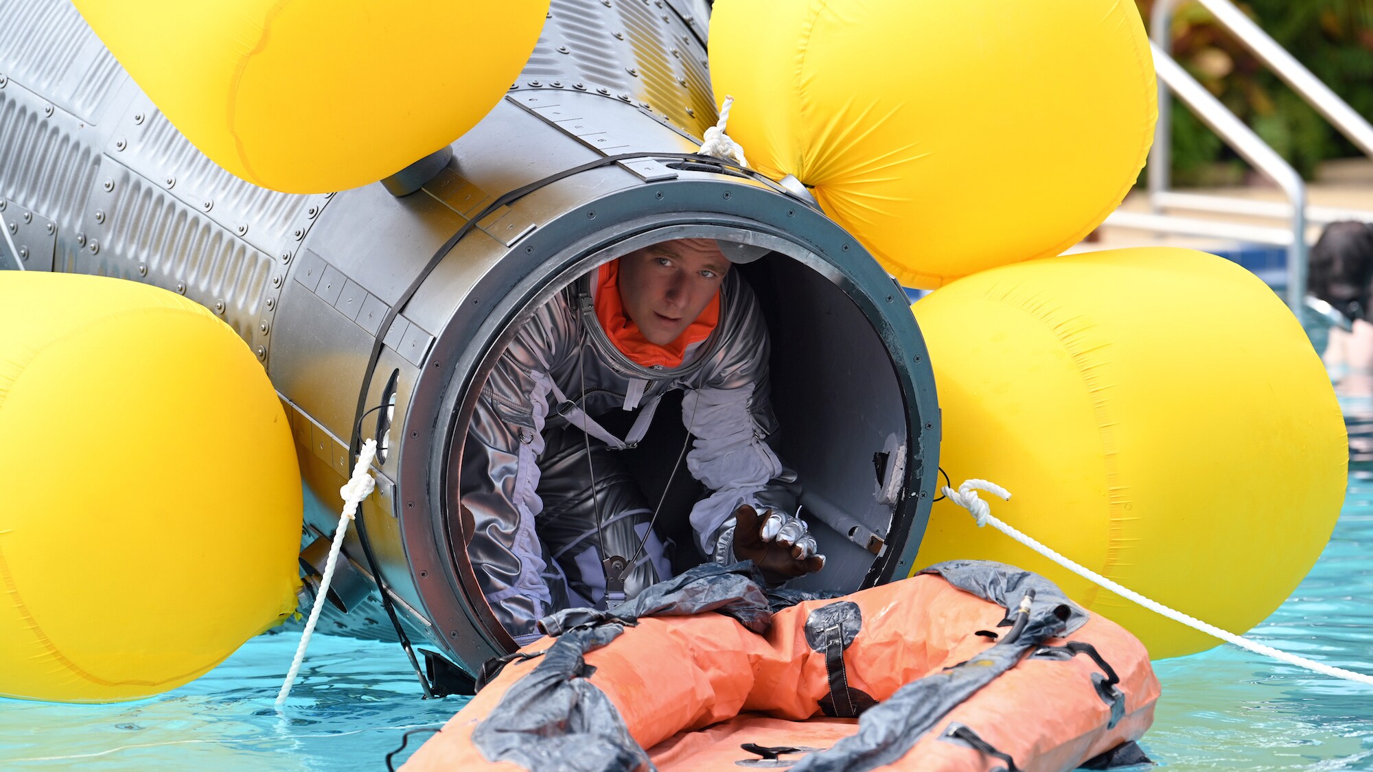 Jake McDorman as Alan Shepard during an emergency procedure demonstration in a swimming pool for Dr. Jerome Wiesner and other members of the President’s Science Advisory Committee (not pictured) in National Geographic's THE RIGHT STUFF streaming on Disney+. (Credit: National Geographic/Gene Page)