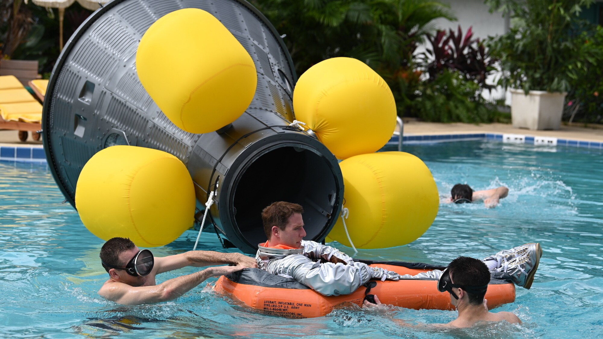 Jake McDorman as Alan Shepard (center) during an emergency procedure demonstration in a swimming pool for Dr. Jerome Wiesner and other members of the President’s Science Advisory Committee (not pictured) in National Geographic's THE RIGHT STUFF streaming on Disney+. (Credit: National Geographic/Gene Page)