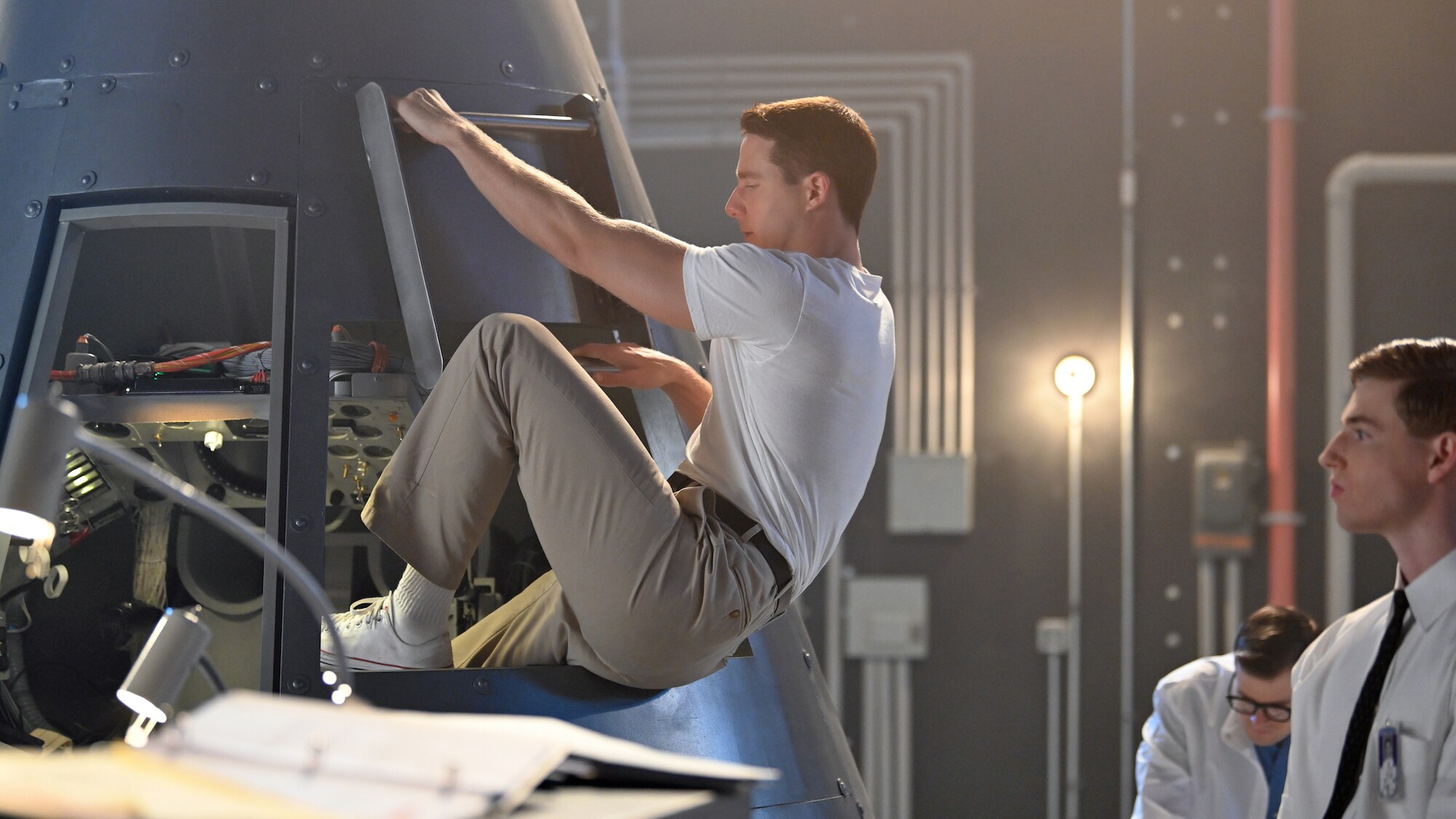 Glynn Lunney played by Jackson Pace stands by while Alan Shepard played by Jake McDorman enters the trainer capsule during a practice session in National Geographic's THE RIGHT STUFF. (Credit: National Geographic/Gene Page)