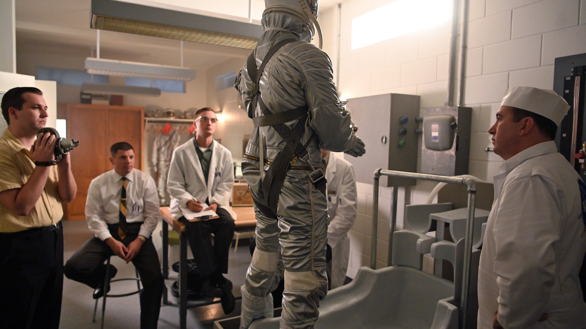 Alan Shepard (standing center), played by Jake McDorman, in space suit in National Geographic's THE RIGHT STUFF streaming on Disney+. (National Geographic/Gene Page)