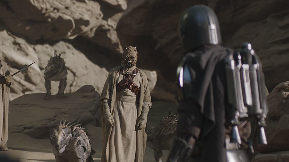 Vanth and the Mandalorian encounter Tusken Raiders in a rocky canyon; although Vanth distrusts th...