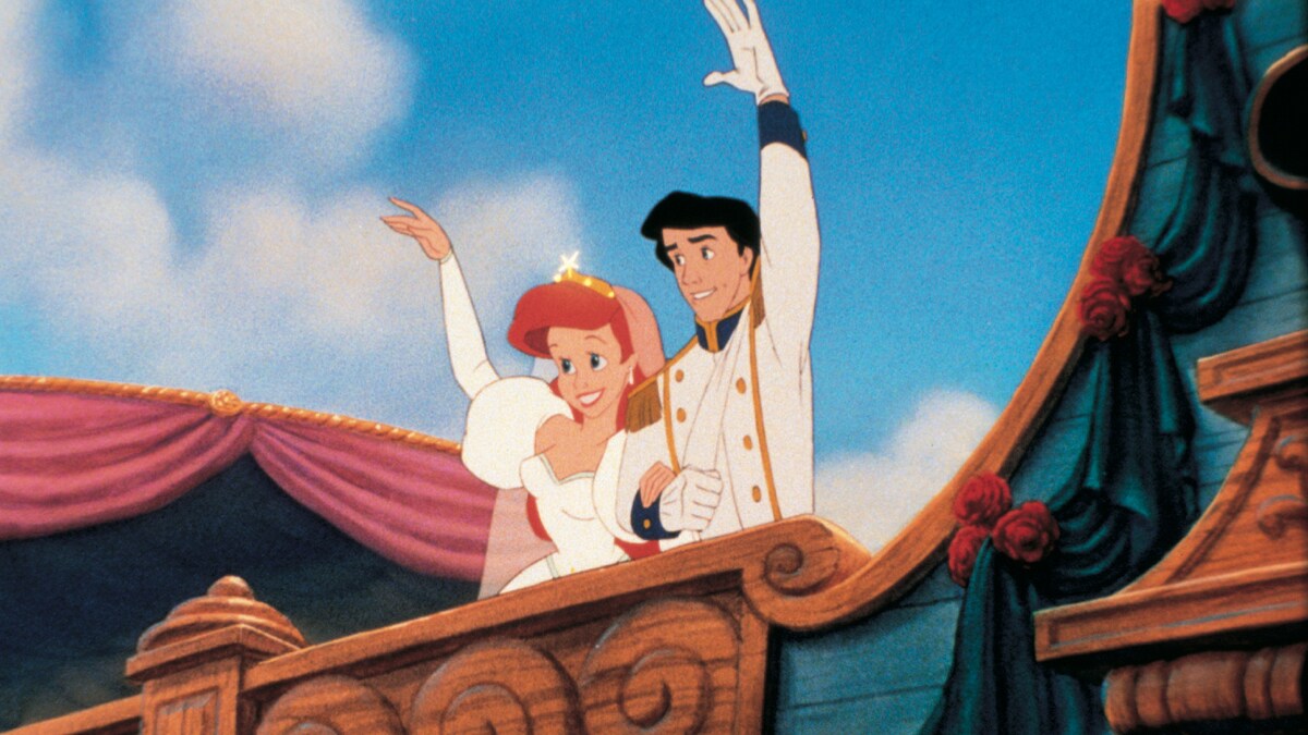 Ariel and Prince Eric waving at people on a boat after getting married