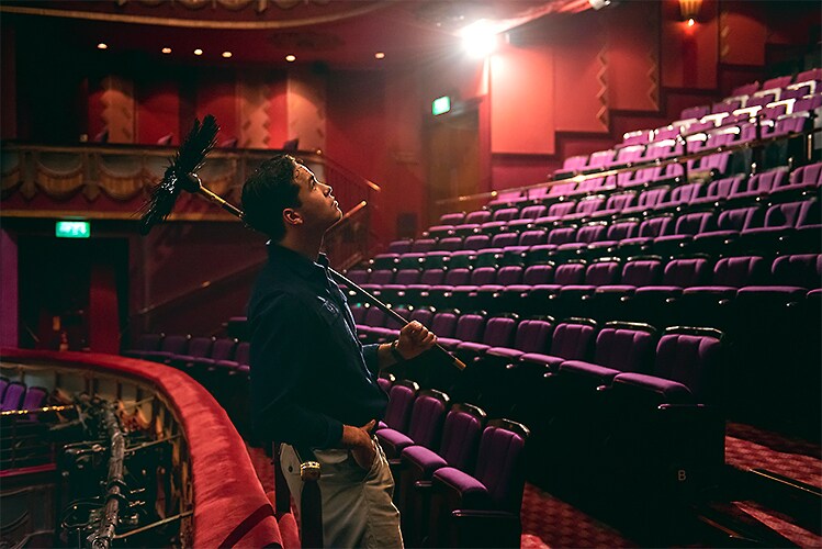 Louis Gaunt posing in the Dress Circle at Prince Edward Theatre.