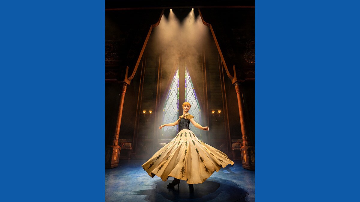 Cheerful Anna in the kingdom palace with her dress raised to the air from dancing.