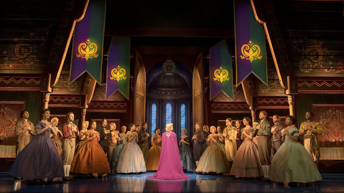 At the coronation, Elsa standing in the middle with the ensemble of Frozen around her