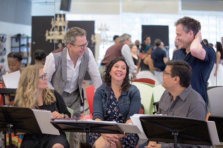 The 5 members of the creative team behind Frozen the Musical laughing together in a rehearsal room.