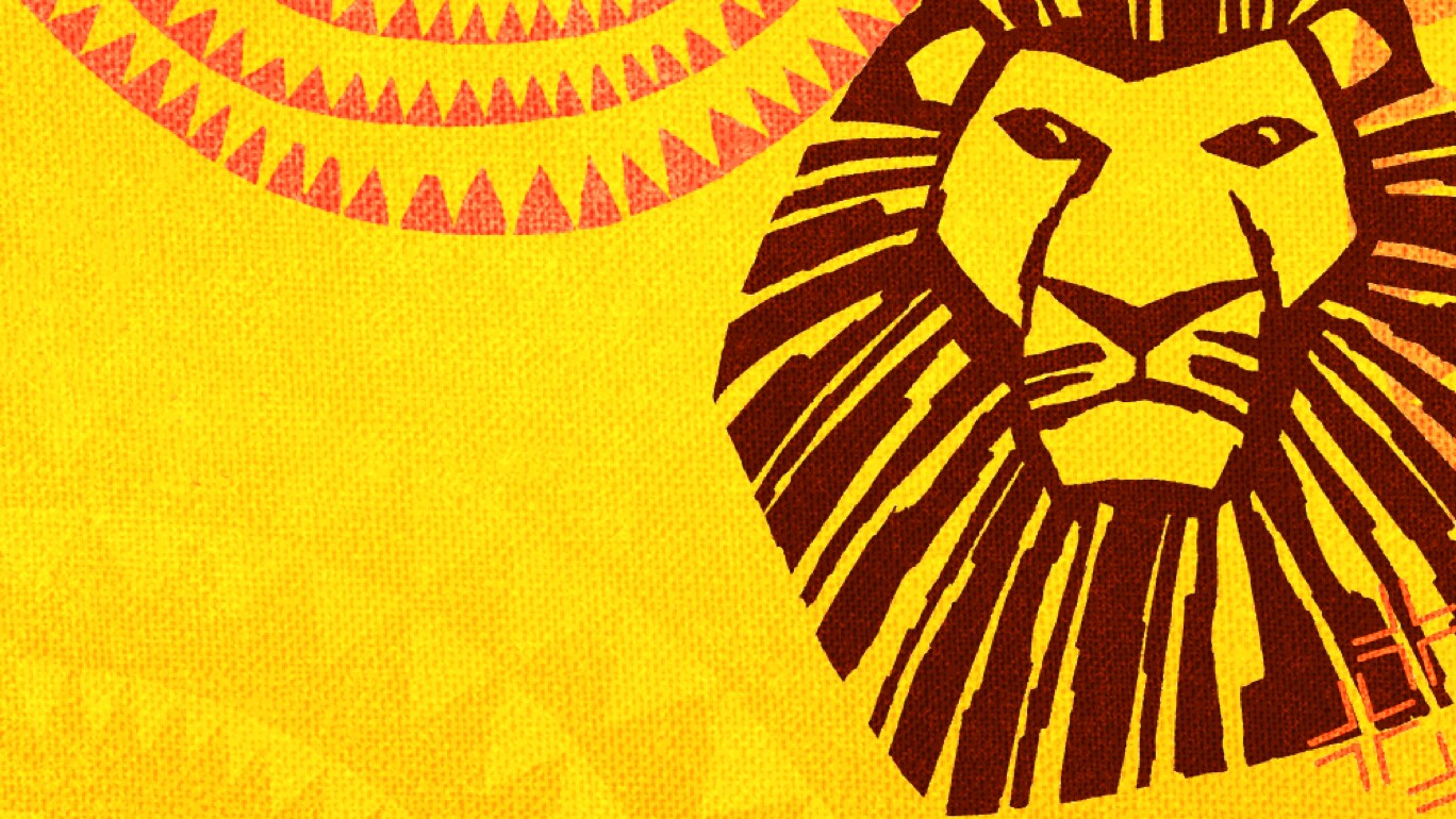 The Lion King Musical poster with lion head on yellow background