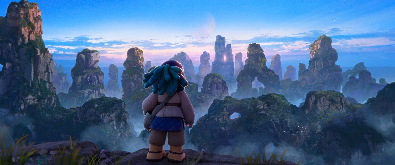 In our introduction to Aau, she scales a mountain and, at the peak, takes in the view.