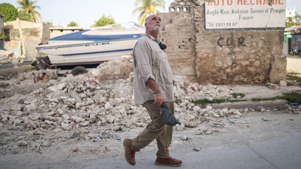 José Andrés walking through rubble from collapsed building remains in Haiti after a 2021 earthquake. (Credit: National Geographic/Clara Wetzel)
