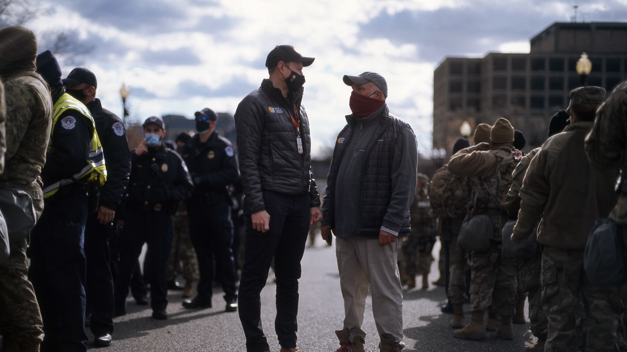 José Andrés (center right) and World Central Kitchen CEO, Nate Mook (center left), have a conversation while surrounded by National Guard units stationed at the US Capitol for the presidential election. (Credit: National Geographic/Dylan Dugas)