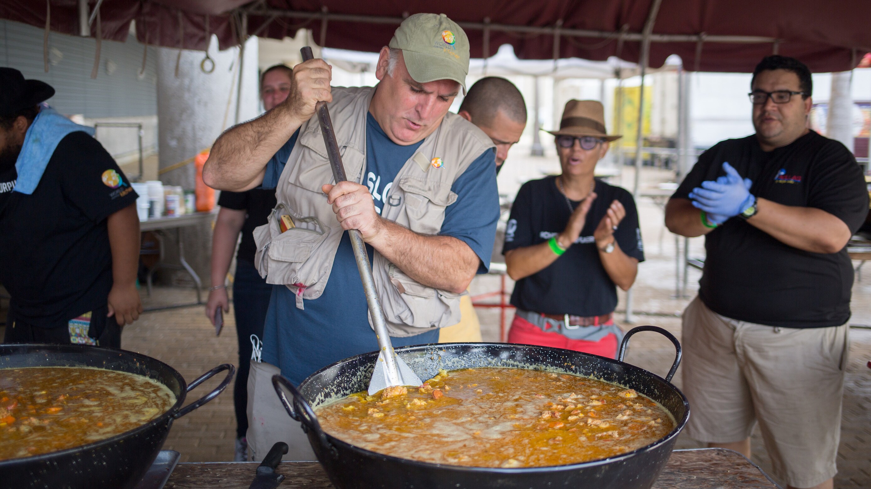 José Andrés (front left) stirs a pot of food in San Juan, Puerto Rico. (Credit: National Geographic)