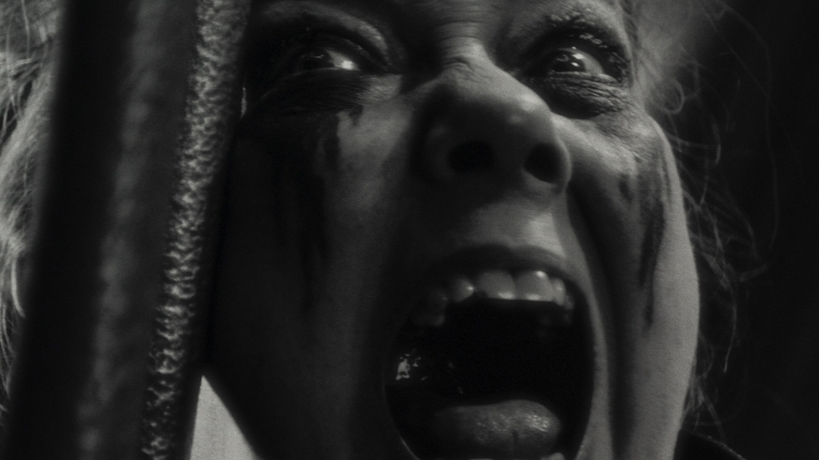 Close up of woman screaming.