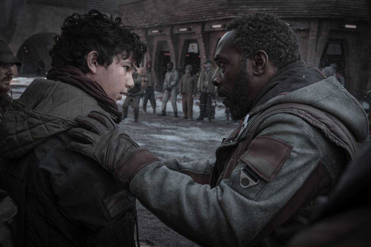 Clem reassures his anxious son before attempting to talk down a group of rock-throwing protestors.