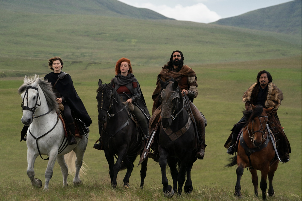 Four people on horses ride along the field in the Disney+ Original series Willow