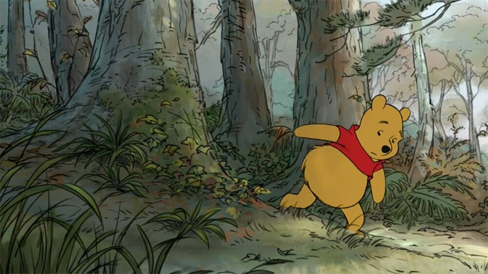 Winnie the Pooh walking in the forest