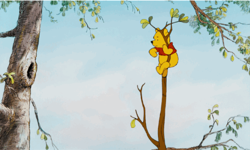 Winnie the Pooh attempting to get honey from a tree.
