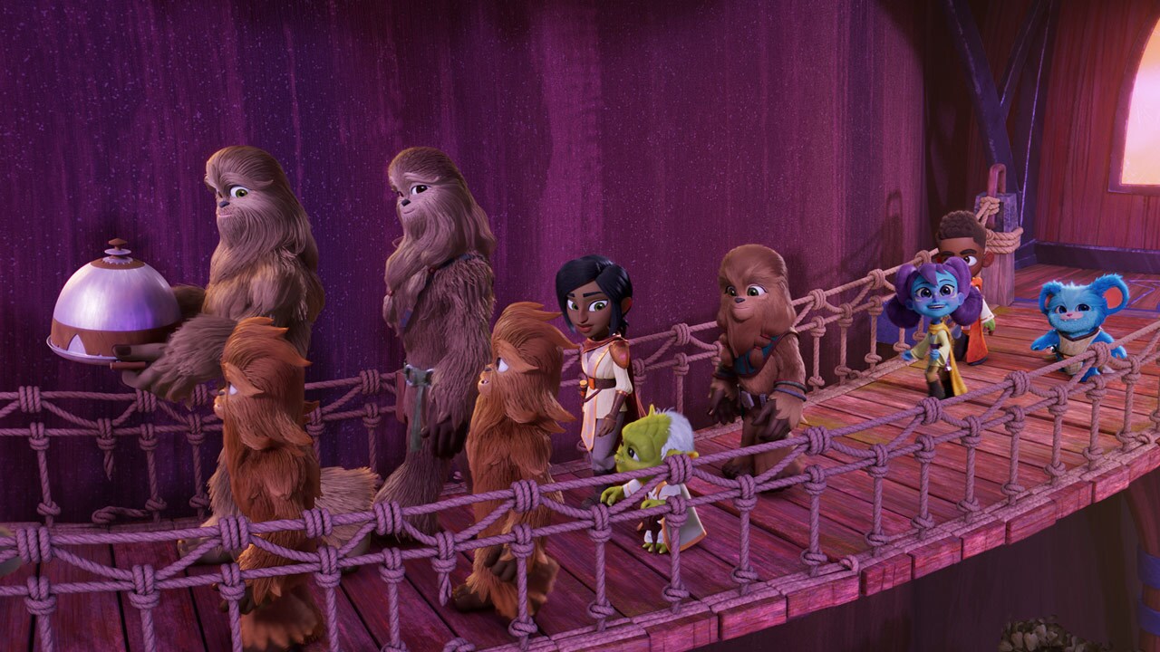 In a scene from Star Wars: Young Jedi Adventures, Kai, Lys, and Nubs, along with Masters Yoda and Zia, walk with Wookiees on a wooden bridge on Kashyyyk.