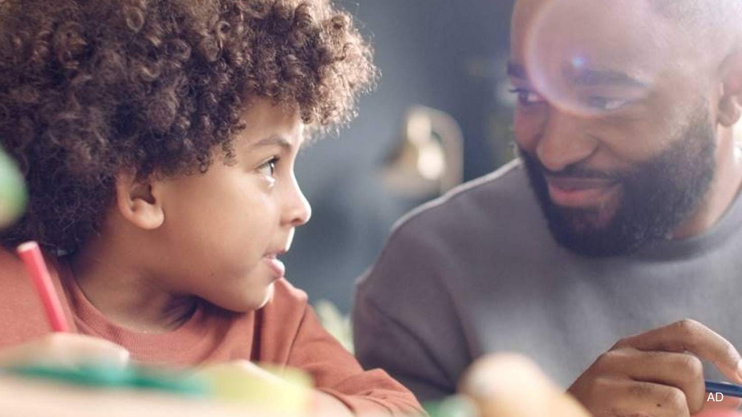 Close-up of a man and child looking at each other